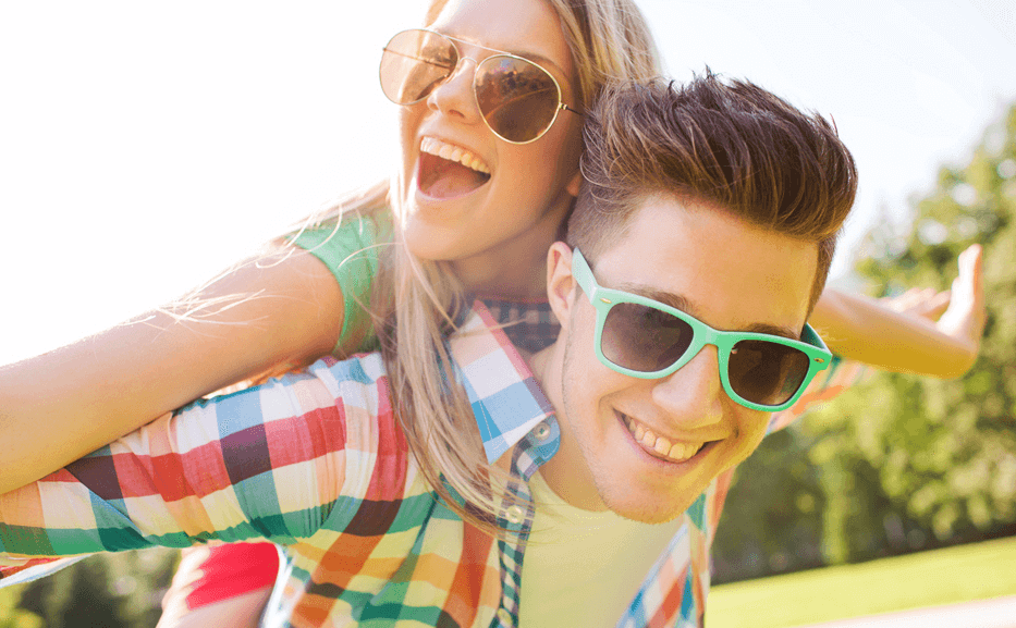 a young couple playfully rejoices outdoors