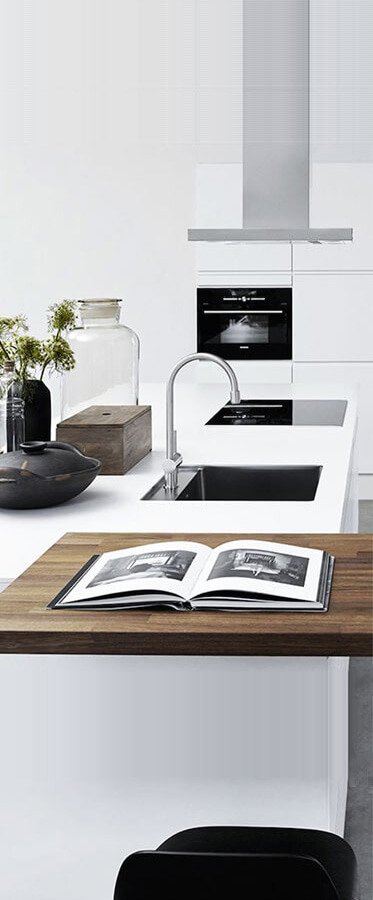 ultra modern kitchen featuring quartz counter glass stove and folk craft kitchen accessories