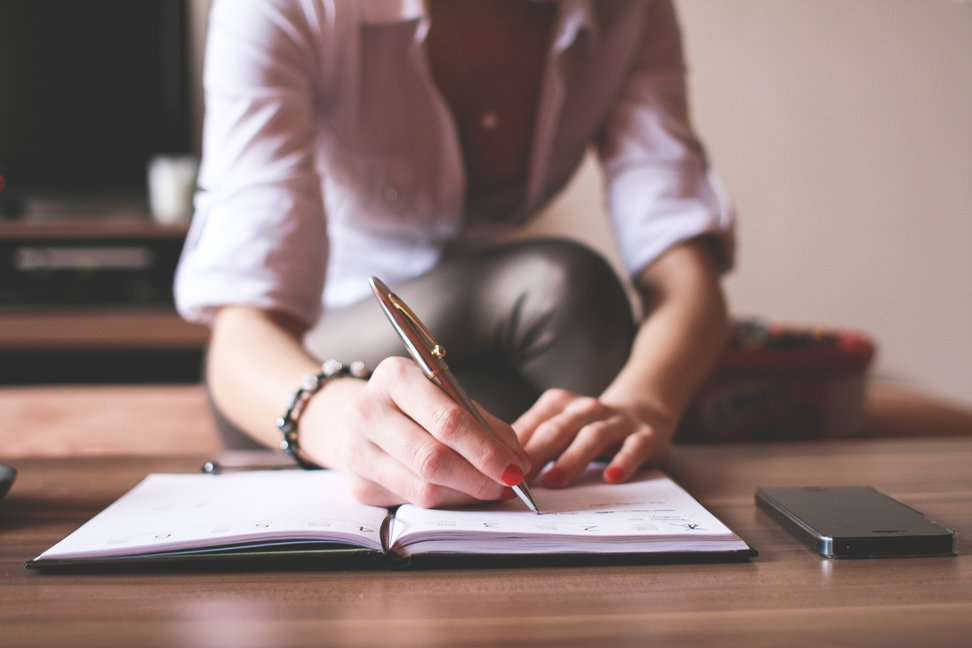 A woman writes in a journal