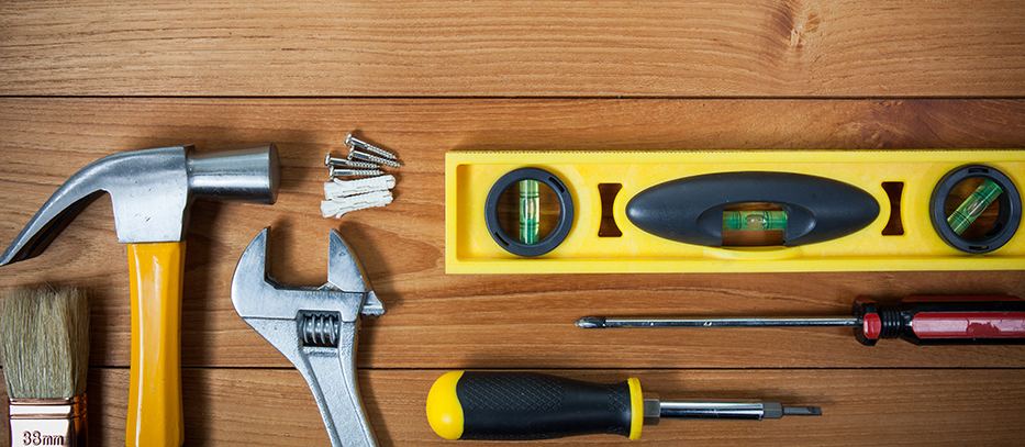 Closeup of assorted work tools on wood