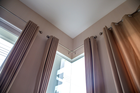 mauve colored blackout curtains covering windows so you can get better sleep.