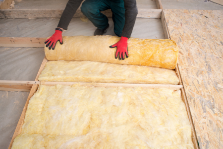 A man checking the insulation in a home.