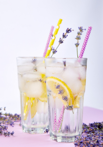 Lavender lemonade mocktail garnished with lavender sprigs and colorful straws.