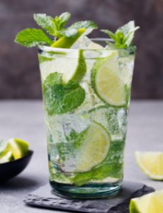 A mojito with limes and mint.