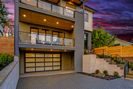 a modern aluminum and glass garage door on a luxury home