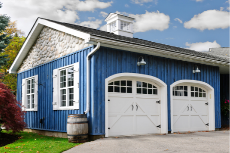 carriage garage doors on a blue home
