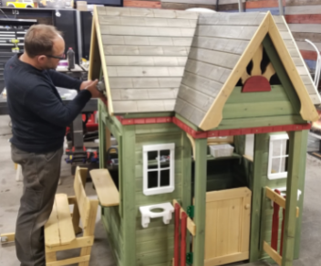 A playhouse desiged as a miniature home to be raffled for charity.