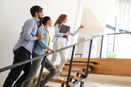 A couple and a realtor are looking at a potential house for must-have home features.