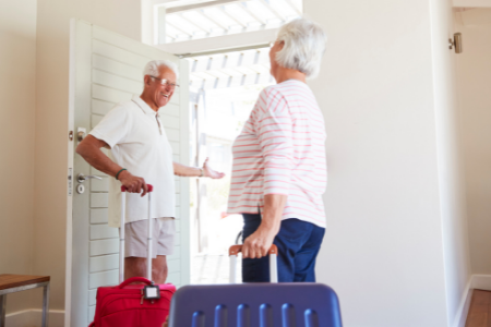 A couple entering their vacation rental for the summer.