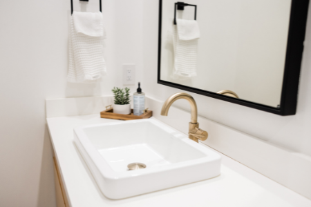 A new faucet with a large mirror, two inexpensive bathroom upgrades.