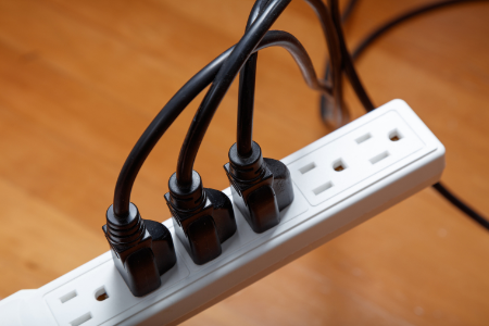 A power strip with 3 plugs connected.