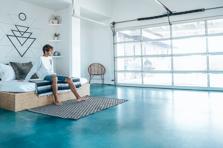 A garage with a blue, colored concrete floor.