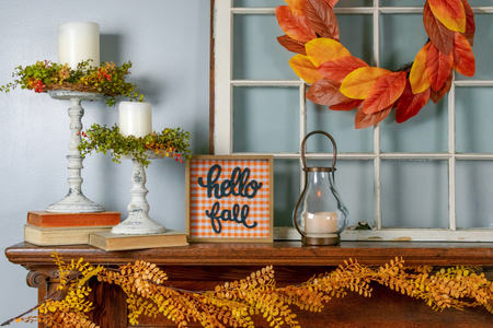 A mantel decorated with fall decor.