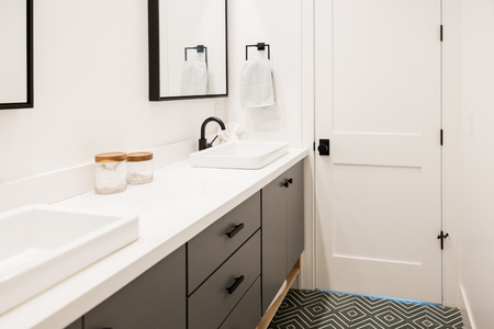 A bathroom that has been updated with new cabinets and countertops.