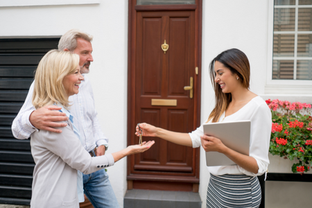 A real estate agent selling a rental property to a middle aged couple.