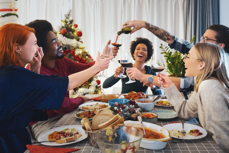 A group of friends celebrating the holiday season with food.