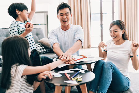 A family doing crafts together as an option for an indoor activity.