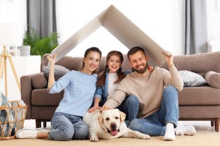 A family with their dog thinking about their future house hunt.