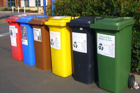 Multi-colored recycling and trash bins intended to reduce waste.