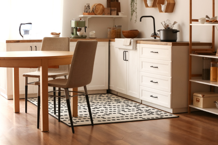 Adding a colorful rug to worn floors is an easy way to update a rental property kitchen.