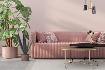 A velvet couch is an elegant way to use pink in interior design.