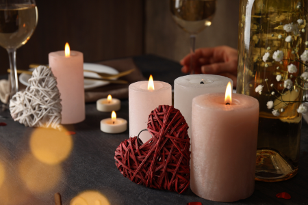 Neutral and pink candles mixed with Valentine's Day decor.