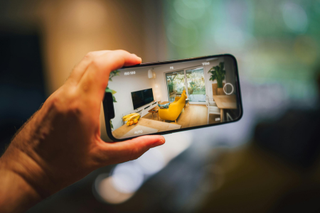 A cell phone captures images that will be used by artificial intelligence to create real estate valuations.