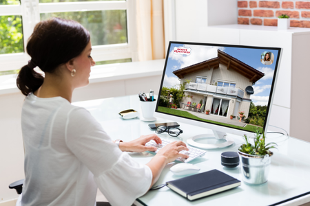 A consumer viewing an agent website, one of the real estate marketing materials needed to build your brand.