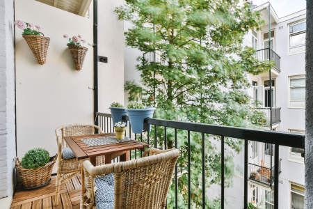 A small balcony using potted plants to add greenery to the space.