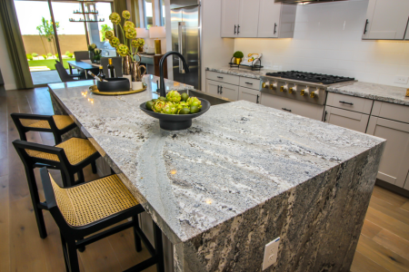 A kitchen with a waterfall style marble countertop, one of the home features that appeals to middle-aged buyers.