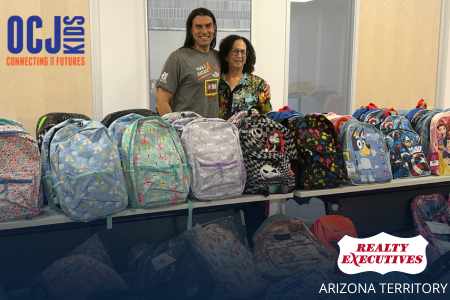 Saresse Zelman and a representative from OCJ Kids with their backpack donations.