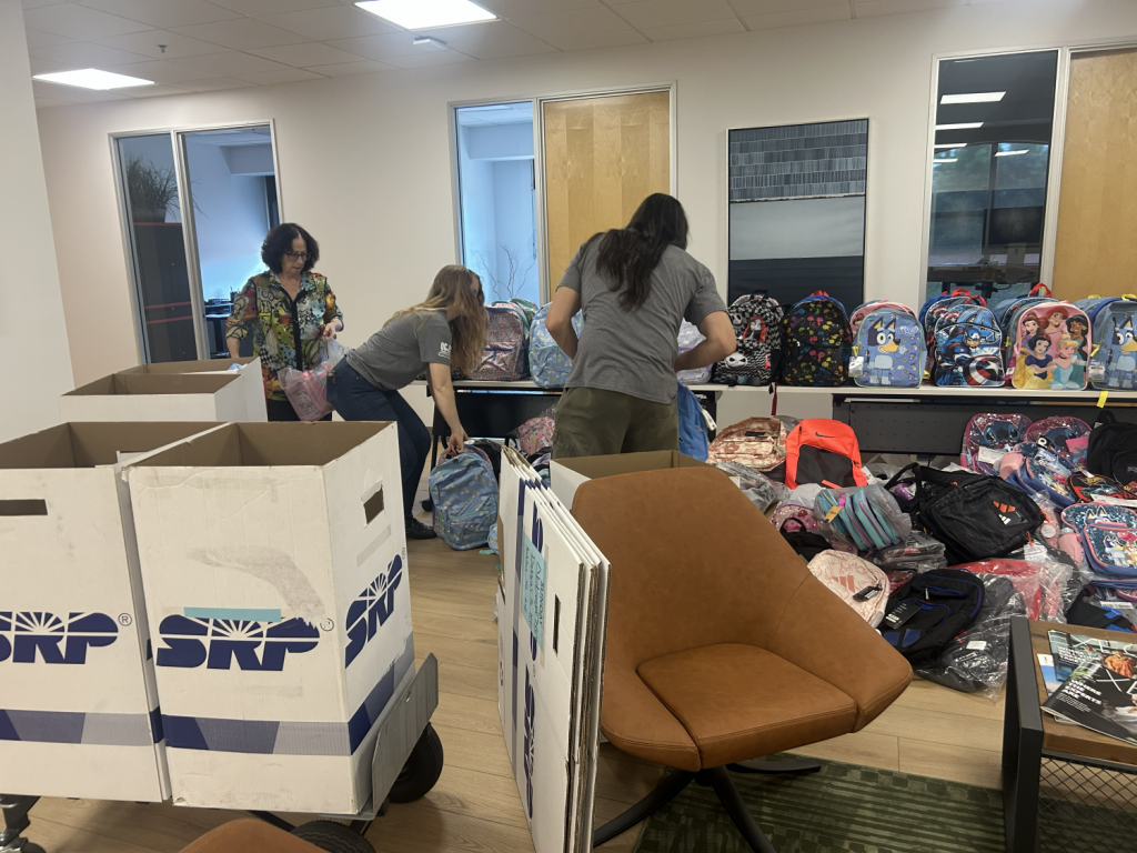 The team collects backpacks for OCJ Kids.