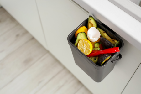 A small indoor container can be used to transfer scraps to a backyard compost bin.
