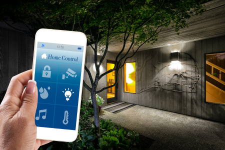A front entryway with a smart video doorbell, smart lock, and smart lights controlled by a cell phone.