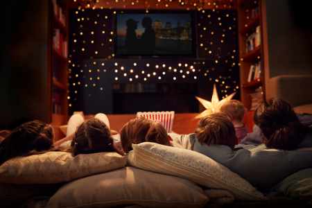 A family enjoying their at-home movie theater corner.